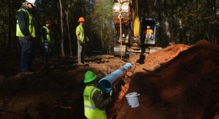 Contractors working for Monroe County lay water pipes, on Tuesday, November 9, 2021, near Juliette. (Elijah Nouvelage for The Atlanta Journal-Constitution)