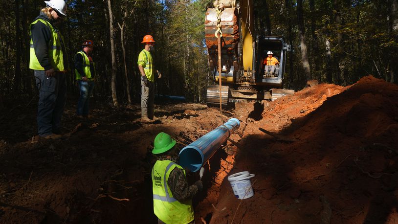 Contractors working for Monroe County lay water pipes, on Tuesday, November 9, 2021, near Juliette. (Elijah Nouvelage for The Atlanta Journal-Constitution)